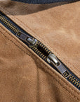 Waxed canvas duffel bag with webbing straps, padded handle and brass zipper