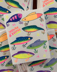Colorful fishing lure stickers with 'You're a Keeper' text on a white background.