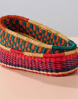 Add these bright, handcrafted baskets to your table, shelf or closet - the uses are limited only by your imagination! Gorgeously handwoven from locally sourced veta vera grass, the utilitarian design features an assortment of vibrant colors. Each one is woven while wet and can be re-shaped by adding water, perfect for the kitchen and bath! Durable and washable, these baskets are a beautiful and unique addition to any decor. 