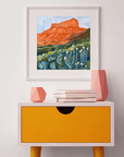 Catch a West Texas sunset without leaving your living room. This vibrant 12 x 12 inch art print by Austin artist El Baker captures the glowing red cliffs and wild desert blooms of Big Bend National Park. The bold brushstrokes and warm hues bring the landscape to life, evoking the magic of golden hour in one of Texas’s most iconic parks.
This high-quality fine art giclée print highlights the rich color and texture of the original painting. Created on thick, durable matte paper, each museum-quality art