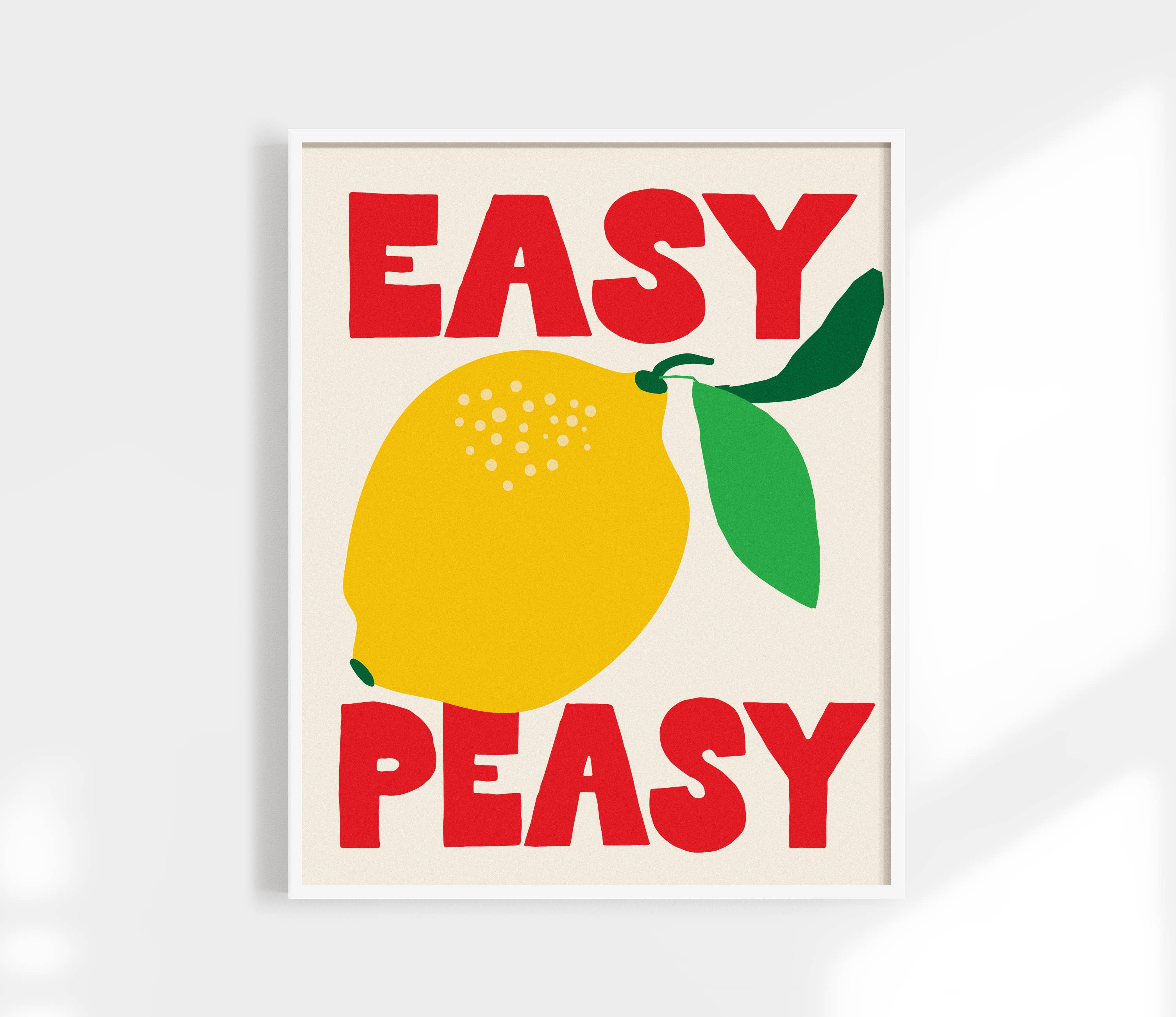 Add a splash of playful charm to your space with the Easy Peasy Lemon Squeezy Art Print by Kuku Studio. Featuring bold hand-drawn lettering and vibrant illustrations of lemons, this design pops in bright red, green, and yellow on a clean neutral background. Printed on luxe, giclée-quality matte paper, each print is designed and produced in Kuku Studio’s San Diego home studio.