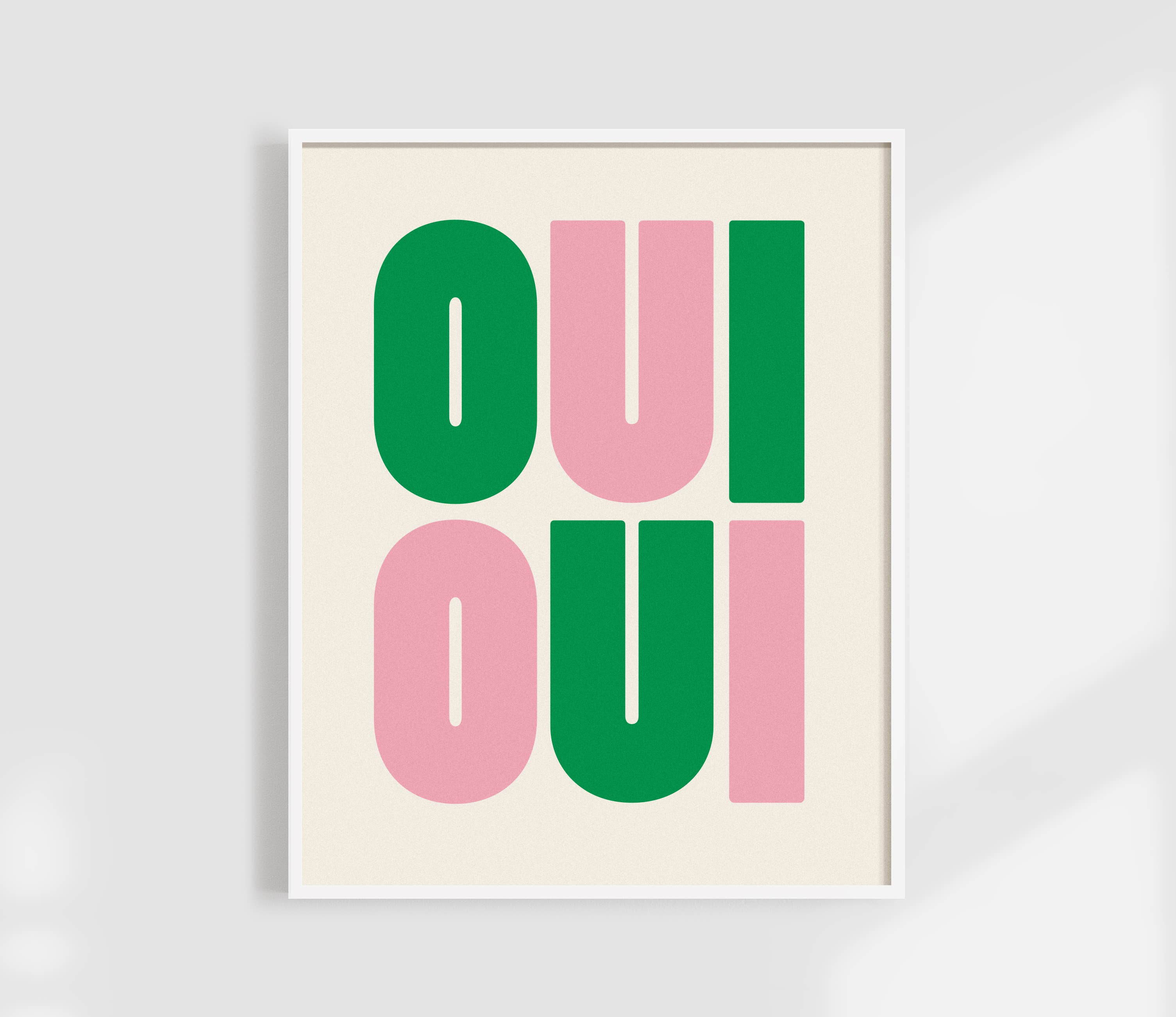 Say it twice with this bold Oui Oui art print. Pink and green text on a clean neutral background adds playful charm to any bathroom or gallery wall.