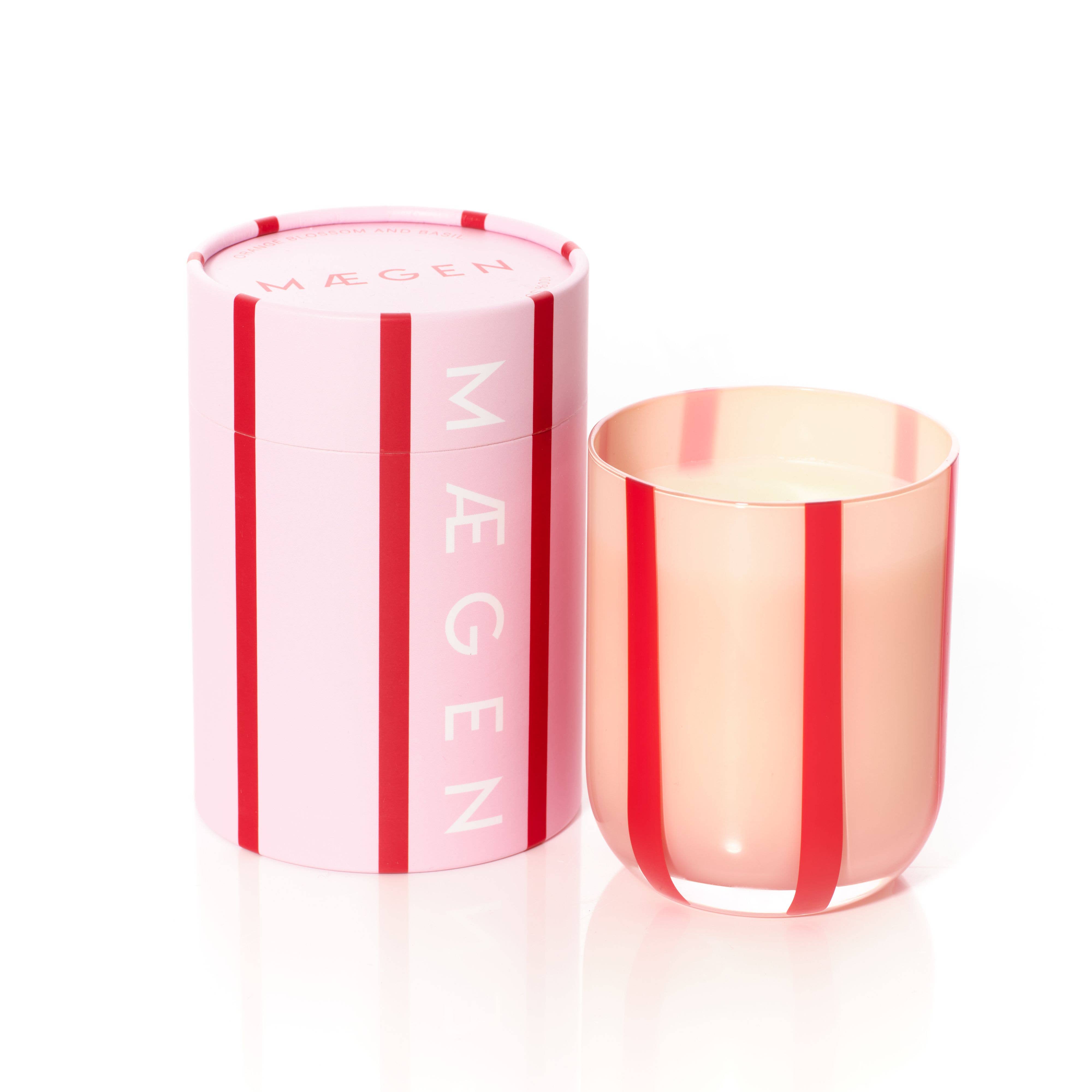 Colorful glass candle with orange blossom & basil scent. Made with clean-burning soy wax. Reuse the striped vessel as bold, playful glassware.