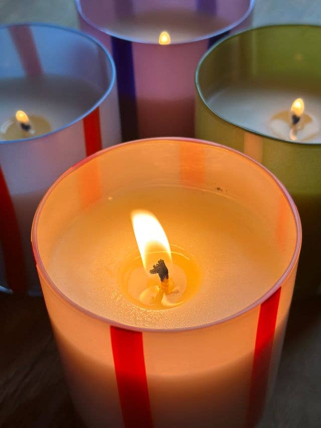 Colorful glass candle with orange blossom & basil scent. Made with clean-burning soy wax. Reuse the striped vessel as bold, playful glassware.