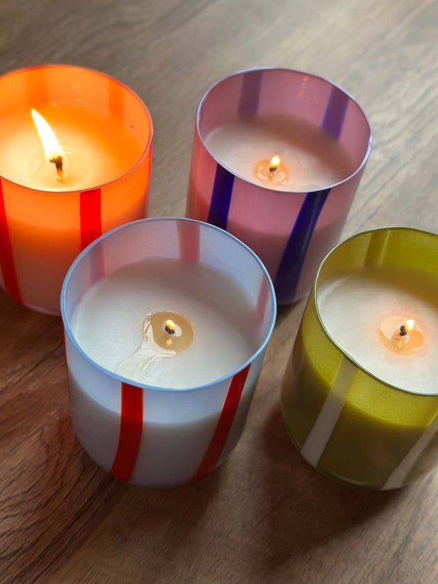 Colorful glass candle with orange blossom & basil scent. Made with clean-burning soy wax. Reuse the striped vessel as bold, playful glassware.