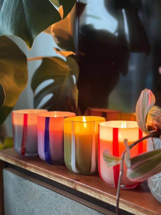 Colorful glass candle with orange blossom & basil scent. Made with clean-burning soy wax. Reuse the striped vessel as bold, playful glassware.