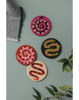 Set of 4 beaded coasters from Danica Studio’s Gardenland collection featuring bold snakes in earthy greens with pops of pink and red. Durable and eye-catching.
