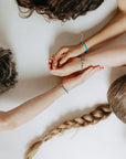 Part of our nostalgic friendship bracelet collection, this version features beautifully crafted Japanese glass beads strung on durable, comfortable cord and finished with a 14k gold-filled sliding clasp. It offers the same unisexy, elevated take on throwback style, perfect for stacking or wearing solo.