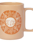 Beige mug with a sun design featuring a face on a white background
