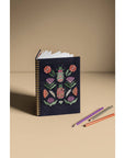 Empower your dreams with the Amulet Embroidered Notebook, featuring protective symbols and high-quality screen printing in a striking ring-bound design.
