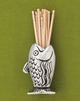Keep your toothpicks within reach with a playful Fish Toothpick Holder. It's the perfect gift for the avid fisherman in your life or someone that just enjoys a cute table accessory. It's not just for toothpicks; it makes a great match holder too! Fine hand-crafted pewter, made in Canada.