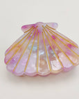 Bring a touch of beachy charm to your hairstyle with this pink shell-shaped hair claw clip. Made from lightweight acrylic, it holds hair securely while adding a playful, summery accent to any look. Perfect for everyday wear or for layering with other clips for a fun, stylish statement.