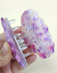 Bring a touch of beachy charm to your hairstyle with this pink shell-shaped hair claw clip. Made from lightweight acrylic, it holds hair securely while adding a playful, summery accent to any look. Perfect for everyday wear or for layering with other clips for a fun, stylish statement.