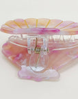 Bring a touch of beachy charm to your hairstyle with this pink shell-shaped hair claw clip. Made from lightweight acrylic, it holds hair securely while adding a playful, summery accent to any look. Perfect for everyday wear or for layering with other clips for a fun, stylish statement.