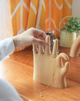 Show off your rings, necklaces, and bracelets with a touch of whimsy. This beech wood jewelry display features a hand making the classic “OK” sign with a playful twist: one extra finger (6 in total) to hold even more of your favorite pieces. Perfect for keeping your jewelry organized and adding a fun, eye-catching accent to your dresser or vanity.