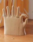 Show off your rings, necklaces, and bracelets with a touch of whimsy. This beech wood jewelry display features a hand making the classic “OK” sign with a playful twist: one extra finger (6 in total) to hold even more of your favorite pieces. Perfect for keeping your jewelry organized and adding a fun, eye-catching accent to your dresser or vanity.