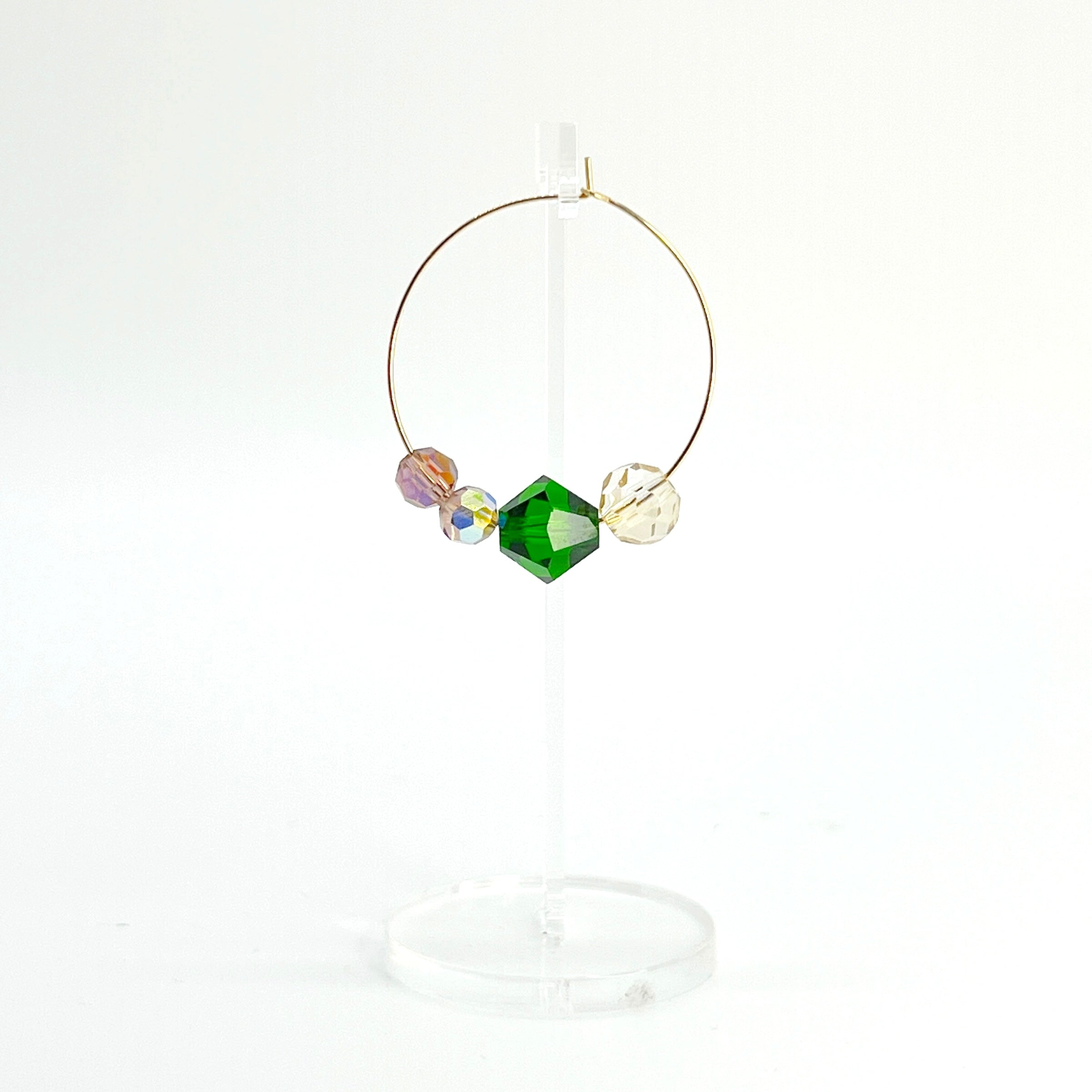 Elegant with a hint of drama, the Large Muse Hoops are a wearable palette of champagne, amethyst, and emerald crystals. Their rich, layered tones and refined silhouette make them a perfect pairing for elevated moments—or everyday beauty with a little mystique.