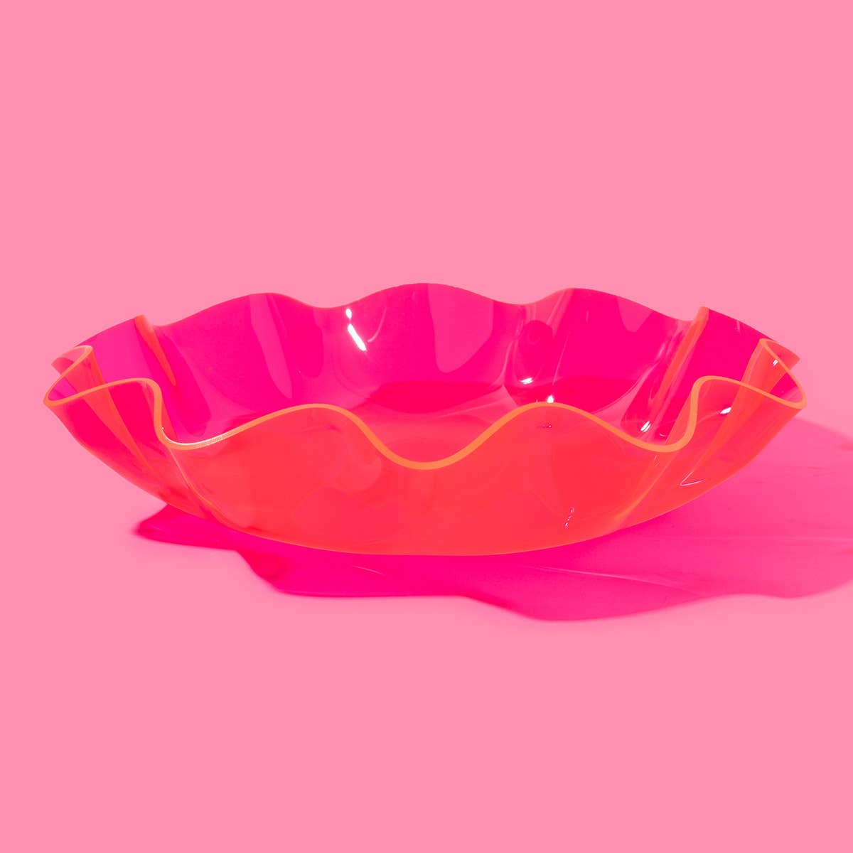 Make a statement with this large wavy acrylic bowl in vibrant pink! Perfect for styling coffee tables and catching everyday essentials, this bold bowl brings both form and function. Its eye-catching shape and playful color make it a standout piece—use it solo or pair it with other sizes for a fun, nested look.