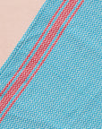 Brighten your kitchen with a pop of color and timeless charm. This striped woven tea towel blends function with simple elegance, featuring a refreshing aqua and white base accented by three bold red stripes at each end. Crafted from 100% cotton, it’s soft, absorbent and ready to tackle daily tasks - from drying dishes to lining a breadbasket. A convenient cotton loop in the corner makes it easy to hang and display. Whether you’re cooking up memories or cleaning up spills, this towel adds a cheerful, artisan