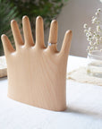 Keep your rings, necklaces, and bracelets organized with a fun twist. This beech wood jewelry display features a regular hand with one extra finger, giving you six spots to hang all your favorite pieces. Perfect for adding a whimsical and functional accent to your dresser or vanity.