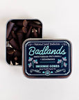 Tin of Badlands incense cones with decorative label on a white background