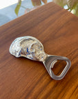 Introducing the Oyster Bottle Opener—a unique and stylish accessory designed for seafood lovers and collectors alike. Crafted in the shape of a clam, this exquisite opener is made from high-quality pewter, adding a touch of elegance to your barware collection. The opener features a durable stainless steel component, ensuring both functionality and charm. Whether you're hosting a seafood feast or adding a nautical touch to your home, this beautifully designed piece combines practicality with artistic flair.
