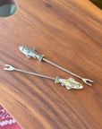 Reel in the compliments with the Pewter Fish Hors d'Oeuvre Pick! Made of pewter with a sturdy stainless steel pick, this charming pick is perfect for both fishing enthusiasts and those looking to add a playful touch to their kitchen or charcuterie board. Fine hand-crafted pewter and stainless steel, made in Canada.