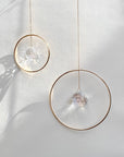 Bring a little sparkle and magic into your home with Prism Ring Suncatchers. Each piece features a golden ring with a prism suspended at its center, designed to catch sunlight and scatter tiny rainbows across your walls and floors. Hang it in a bright window or on a wall to add a touch of light-filled beauty to your space.