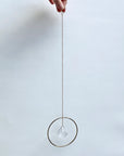 Bring a little sparkle and magic into your home with Prism Ring Suncatchers. Each piece features a golden ring with a prism suspended at its center, designed to catch sunlight and scatter tiny rainbows across your walls and floors. Hang it in a bright window or on a wall to add a touch of light-filled beauty to your space.
