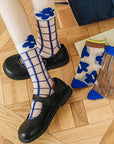 Step up your sock game with these fun, transparent sheer socks. Each pair features playful designs that add a subtle pop of personality to any outfit. Lightweight and breezy, they’re perfect for layering with sneakers, heels, or flats for a whimsical, stylish touch.