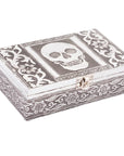 Decorative jewelry box with skull design on a white background