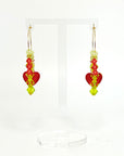 Joyful, flirty, and full of energy—these Small Spark Hoops are a burst of personality. A radiant heart-shaped crystal takes center stage, framed by watermelon and chartreuse tones that feel like summer bottled up. A scattering of dangling crystals adds playful movement, making these hoops perfect for anyone who loves to stand out and shine.