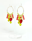 Joyful, flirty, and full of energy—these Small Spark Hoops are a burst of personality. A radiant heart-shaped crystal takes center stage, framed by watermelon and chartreuse tones that feel like summer bottled up. A scattering of dangling crystals adds playful movement, making these hoops perfect for anyone who loves to stand out and shine.