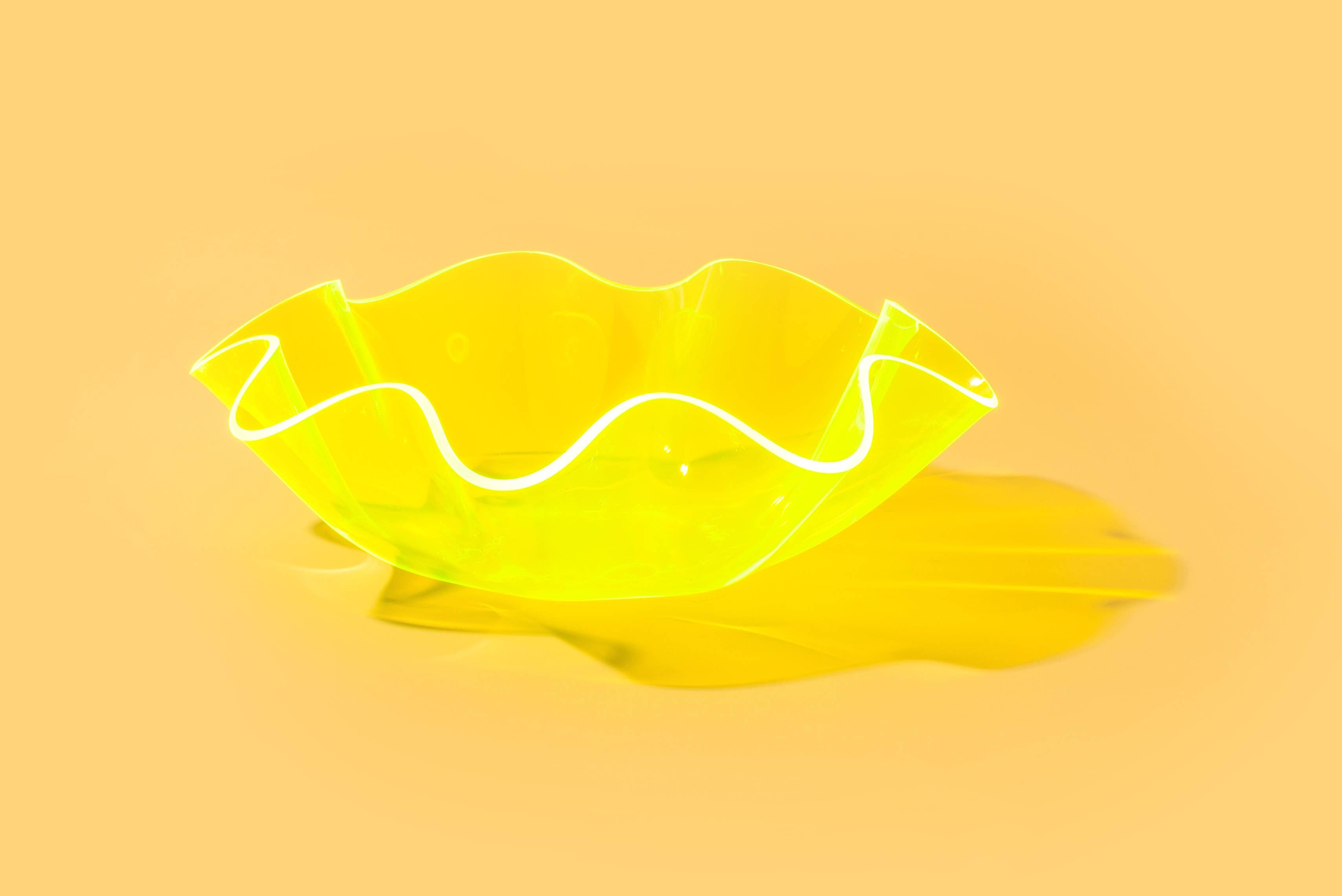 Add a splash of bold color to your space with this neon green wavy acrylic bowl! Its playful shape and vibrant hue make it perfect for catching keys or styling on a shelf. Made from durable acrylic, it’s both functional and eye-catching—great on its own or nested with other bowls for a layered look.