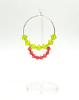 Joyful, flirty, and full of energy—these Small Spark Hoops are a burst of personality. A radiant heart-shaped crystal takes center stage, framed by watermelon and chartreuse tones that feel like summer bottled up. A scattering of dangling crystals adds playful movement, making these hoops perfect for anyone who loves to stand out and shine.