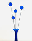 Bring a pop of color and artistry to your home with this handcrafted set of stained glass blue globe thistles by Samara Designs Studio. Each stem is carefully handmade using cobalt blue stained glass, cut and assembled with care to create a lasting botanical accent that will never wilt or fade.