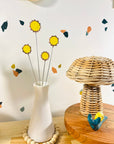 Handmade stained glass buttercups add bright yellow charm to any space. Pet-safe, low-maintenance decor for vases or planters. Set of four stems.