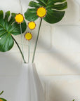 Handmade stained glass buttercups add bright yellow charm to any space. Pet-safe, low-maintenance decor for vases or planters. Set of four stems.