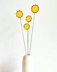 Handmade stained glass buttercups add bright yellow charm to any space. Pet-safe, low-maintenance decor for vases or planters. Set of four stems.