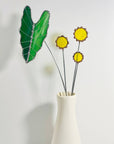 Handmade stained glass buttercups add bright yellow charm to any space. Pet-safe, low-maintenance decor for vases or planters. Set of four stems.