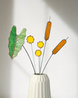 Bring a pop of color and artistry to your home with this handcrafted stained glass tropical green Alocasia leaf by Samara Designs Studio. This artistic interpretation captures the unique shape of the Alocasia leaf in lasting stained glass that will never wilt or fade. Each leaf is carefully handmade using stained glass and galvanized steel wire for a durable botanical accent.