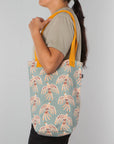 Lightweight and sturdy, this Plume Studio Tote by Danica Studio features reinforced handles and a bold feather design inspired by nature's beauty.