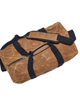 Waxed canvas duffel bag with webbing straps, padded handle and brass zipper