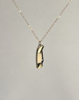 Mini bone-handled pocket knife pendant, closed, hanging from a gold-filled chain
