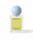Betsey perfume bottle with a light blue sphere cap and chartreuse label on a white background