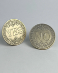Two bronze-finished decision coins, one showing YES and one showing NO, on a light gray background