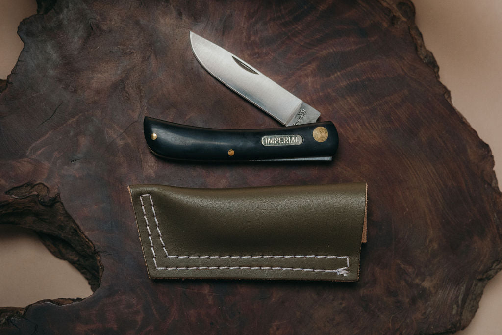 Imperial Schrade pocket knife with an olive leather sheath