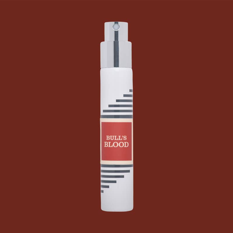 White Imaginary Authors travel spray with a red Bull's Blood label on a dark brown background