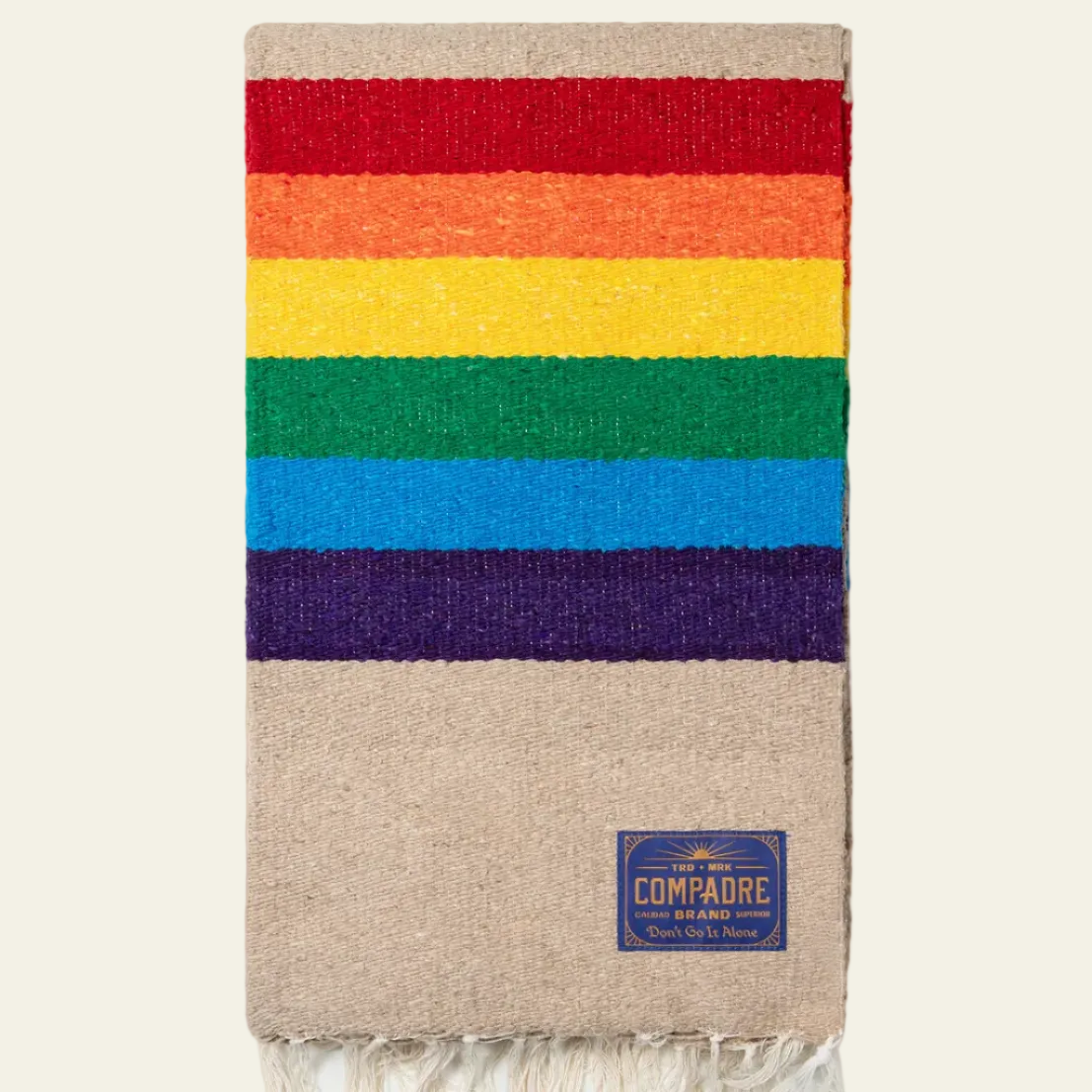 Tan blanket with wide red, orange, yellow, green, blue and purple stripes