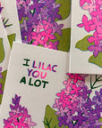 Card with lilac flowers and text 'I Lilac You A Lot' on a white background